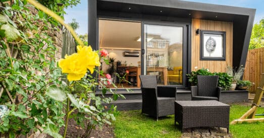 Garden games room and garden bar next to garden furniture.