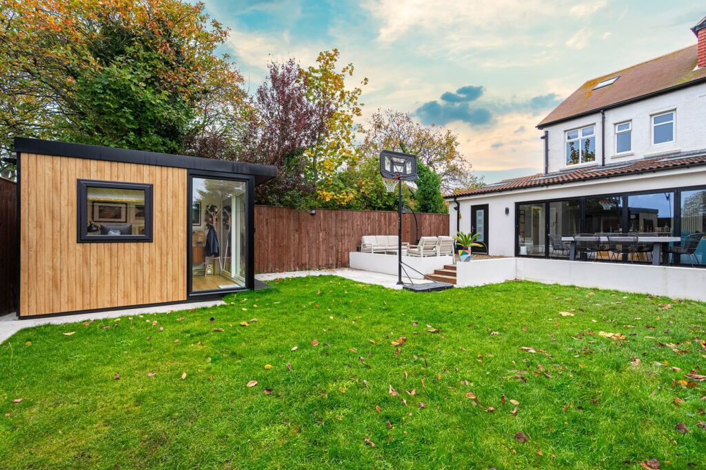 Garden room by house and greenery