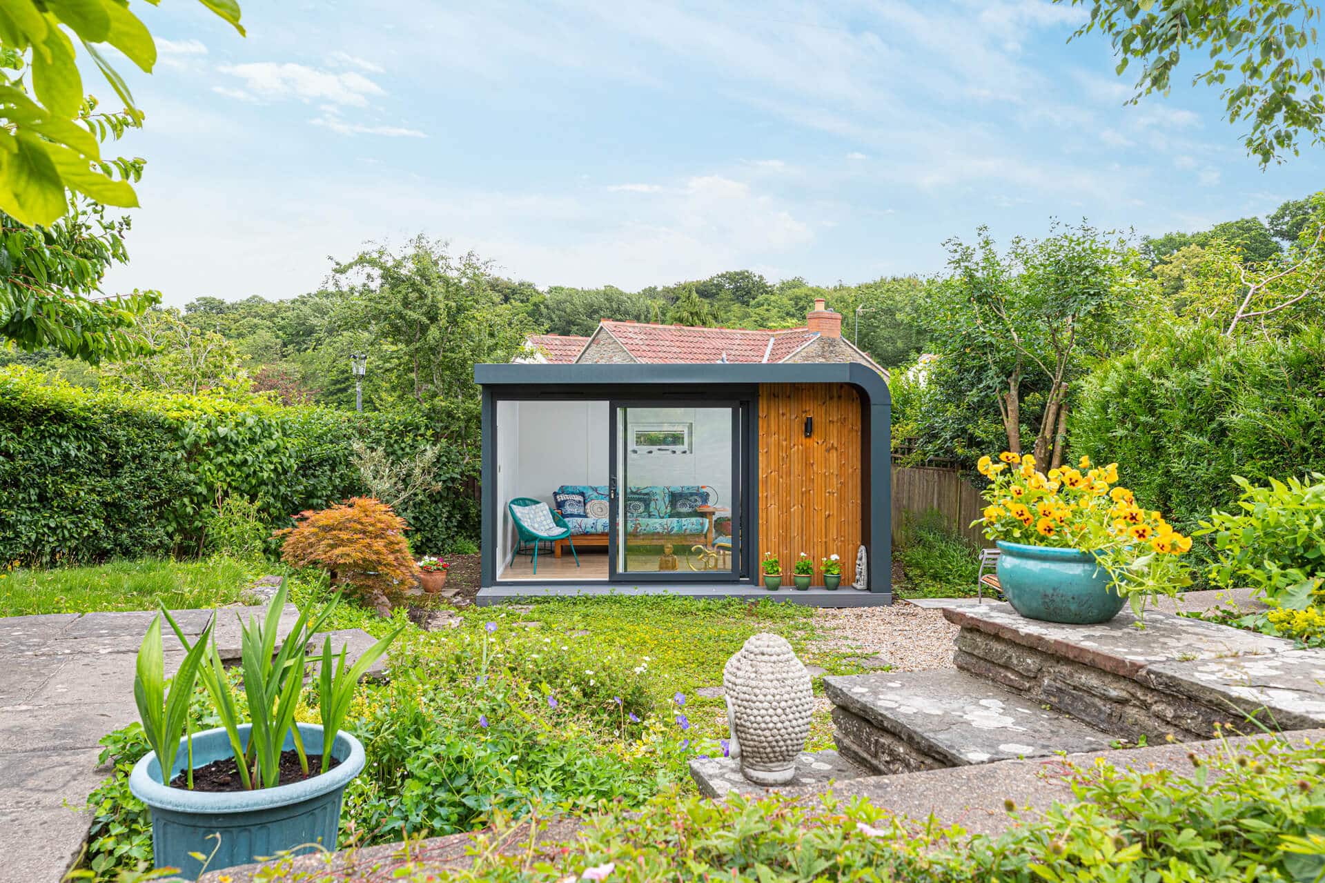 Garden room in the corner of a floral garden