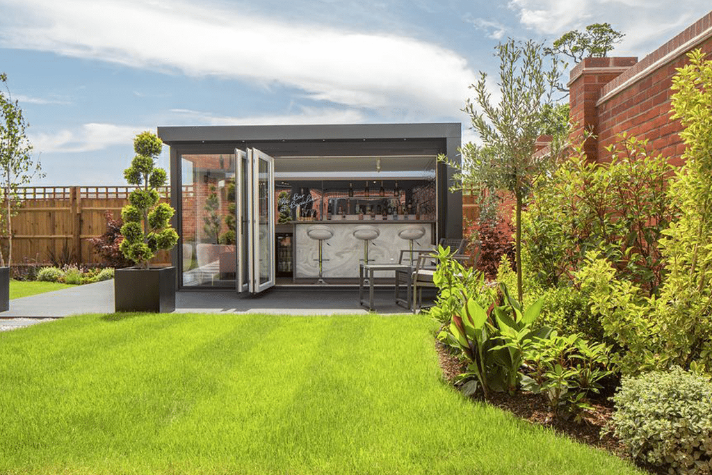 a modern garden room with the doors open